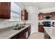 Kitchen boasts granite countertops, double sink, and ample wood cabinetry at 1673 E Jardin Pl, Casa Grande, AZ 85122