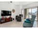 Living room with large TV, comfortable seating and backyard access at 1673 E Jardin Pl, Casa Grande, AZ 85122