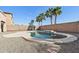 Private backyard oasis with a sparkling pool surrounded by gravel and mature palm trees at 1801 W Nighthawk Way, Phoenix, AZ 85045
