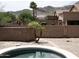 Backyard with brick fence, desert landscaping, trees, and mountain views at 1801 W Nighthawk Way, Phoenix, AZ 85045