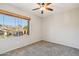 Cozy bedroom featuring carpet and a large window, offering pleasant neighborhood views and natural light at 1801 W Nighthawk Way, Phoenix, AZ 85045