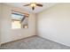 Well-lit bedroom featuring a ceiling fan and a window that provides ample natural light at 1801 W Nighthawk Way, Phoenix, AZ 85045