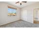 Comfortable bedroom with a ceiling fan and a window view, complemented by a closet for storage at 1801 W Nighthawk Way, Phoenix, AZ 85045