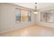 Bright dining room featuring tile flooring, large windows with blinds, and a pendant light fixture at 1801 W Nighthawk Way, Phoenix, AZ 85045