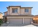 Charming two-story home featuring a three-car garage, desert landscaping, and stucco facade at 1801 W Nighthawk Way, Phoenix, AZ 85045