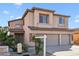View of a well-maintained two-story home with a three-car garage and desert landscaping at 1801 W Nighthawk Way, Phoenix, AZ 85045
