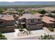 Two-story home with desert landscaping, spacious driveway, and two-car garage, situated in a community with distant mountain views at 1801 W Nighthawk Way, Phoenix, AZ 85045