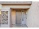 View of a covered front porch and entryway with decorative stonework around the door at 1801 W Nighthawk Way, Phoenix, AZ 85045