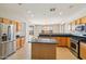 Open-concept kitchen features an island, wood cabinets, granite countertops, stainless steel appliances and backyard access at 1801 W Nighthawk Way, Phoenix, AZ 85045