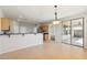 Spacious eat-in kitchen featuring tile floors, breakfast bar, and sliding glass doors to the backyard patio at 1801 W Nighthawk Way, Phoenix, AZ 85045