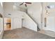 Open-concept living room with carpet flooring, high ceilings, ceiling fan, and staircase at 1801 W Nighthawk Way, Phoenix, AZ 85045