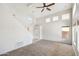 Bright living room with carpet flooring, vaulted ceilings, lots of natural light, and ceiling fan at 1801 W Nighthawk Way, Phoenix, AZ 85045