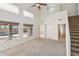 Spacious living room with carpet flooring, staircase, ceiling fan, and views of the backyard pool at 1801 W Nighthawk Way, Phoenix, AZ 85045
