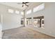 Bright, spacious living room with soaring ceilings, carpet flooring, and multiple large windows at 1801 W Nighthawk Way, Phoenix, AZ 85045