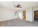 Neutral main bedroom showcasing an arched entry to the en suite bathroom and a ceiling fan with lighting at 1801 W Nighthawk Way, Phoenix, AZ 85045