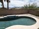 Backyard pool with brick privacy fence, desert landscaping, and mature trees at 1801 W Nighthawk Way, Phoenix, AZ 85045