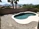 Kidney-shaped backyard pool with light tile and concrete patio at 1801 W Nighthawk Way, Phoenix, AZ 85045