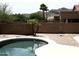 Backyard pool with desert landscaping, mature trees, and brick privacy fence at 1801 W Nighthawk Way, Phoenix, AZ 85045