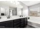 Bathroom with a double vanity, bathtub and window at 18320 N Betty Ct, Maricopa, AZ 85138