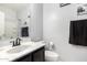Clean bathroom with dark vanity, shower, and toilet at 18320 N Betty Ct, Maricopa, AZ 85138