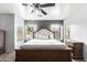 Main bedroom with king-size bed and ceiling fan at 18320 N Betty Ct, Maricopa, AZ 85138
