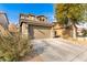 Two-story house with a two-car garage, driveway, and mature trees at 18320 N Betty Ct, Maricopa, AZ 85138