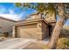 Two-story house with a two-car garage and a tree in front at 18320 N Betty Ct, Maricopa, AZ 85138