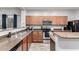 Kitchen with wood cabinets, granite countertops, and stainless steel appliances at 18320 N Betty Ct, Maricopa, AZ 85138