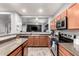 Kitchen with wood cabinets, granite countertops, and stainless steel appliances at 18320 N Betty Ct, Maricopa, AZ 85138