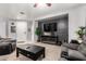 Living room with grey sofas, a coffee table, and a fireplace at 18320 N Betty Ct, Maricopa, AZ 85138