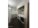 Bright laundry room with washer, dryer, and ample shelving at 2171 N Santiana Pl, Casa Grande, AZ 85122