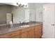 Bathroom with wood cabinets, granite countertop, and updated sink at 2329 N Recker Rd # 23, Mesa, AZ 85215