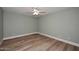Simple bedroom with ceiling fan and wood-look floors at 2329 N Recker Rd # 23, Mesa, AZ 85215