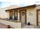 Tan stucco home with a porch, two chairs, and a decorative wreath at 2329 N Recker Rd # 23, Mesa, AZ 85215