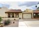 Cute stucco home with tile roof, two-car garage, and landscaped front yard at 2329 N Recker Rd # 23, Mesa, AZ 85215