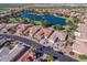 Aerial view of neighborhood with lake and homes at 23610 S Desert Moon Ct, Sun Lakes, AZ 85248