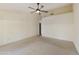 Spacious bedroom with ceiling fan and neutral carpeting at 23610 S Desert Moon Ct, Sun Lakes, AZ 85248