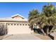 Attached garage with light beige door at 23610 S Desert Moon Ct, Sun Lakes, AZ 85248