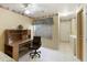 Home office features built-in desk and cabinets, plus a ceiling fan at 23610 S Desert Moon Ct, Sun Lakes, AZ 85248