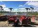 Patio with red chairs and heaters overlooking lake at 23610 S Desert Moon Ct, Sun Lakes, AZ 85248