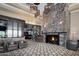 Elegant restaurant lobby with stone fireplace and comfortable seating at 23610 S Desert Moon Ct, Sun Lakes, AZ 85248