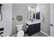 Clean bathroom with a round mirror, navy blue vanity, and white subway tiles at 25582 N 89Th St, Scottsdale, AZ 85255