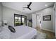 Spacious bedroom with plush bed, ceiling fan and access to backyard at 25582 N 89Th St, Scottsdale, AZ 85255