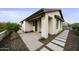 Modern home exterior with light-colored stucco and stone pathway at 25582 N 89Th St, Scottsdale, AZ 85255