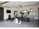 Well-equipped home gym featuring various exercise machines and a TV at 25582 N 89Th St, Scottsdale, AZ 85255