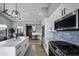 Modern kitchen features white shaker cabinets, stainless steel appliances, and a quartz countertop at 25582 N 89Th St, Scottsdale, AZ 85255