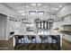 Gourmet kitchen with a large island, white cabinets, and stylish pendant lighting at 25582 N 89Th St, Scottsdale, AZ 85255