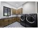 Laundry room with washer, dryer, and stylish patterned tile floor at 25582 N 89Th St, Scottsdale, AZ 85255