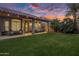 Spacious backyard with covered patio, putting green, and string lights at 26803 N 45Th Pl, Cave Creek, AZ 85331