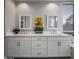 Bathroom with double vanity, large mirrors, and white cabinets at 26803 N 45Th Pl, Cave Creek, AZ 85331